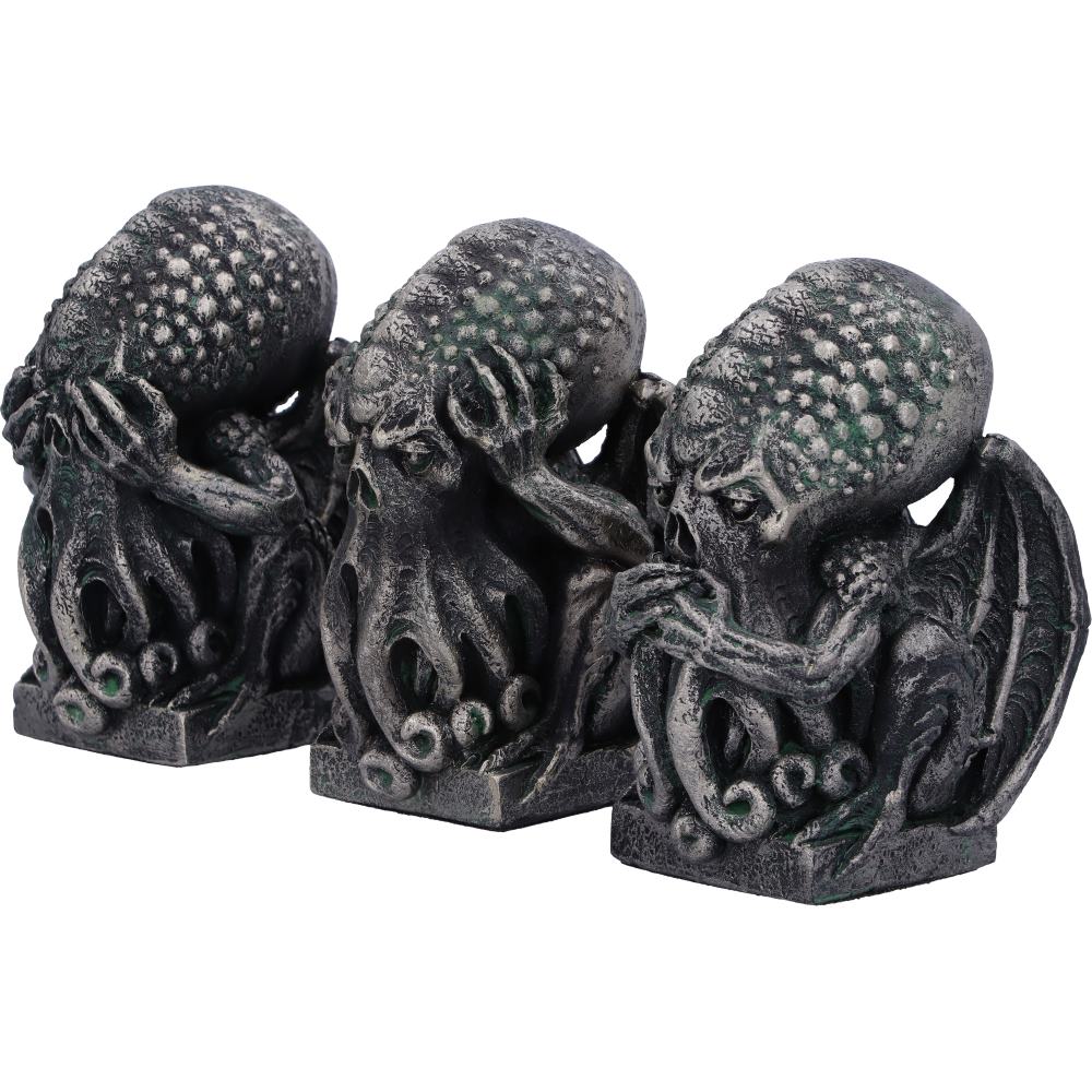 Three dark grey Cthulhu figurines on a white background