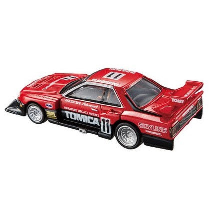 Tomica Premium model car of a Nissan Skyline Turbo Super Silhouette #01 in red and black with Tomica livery out of box. Side view on a white background.