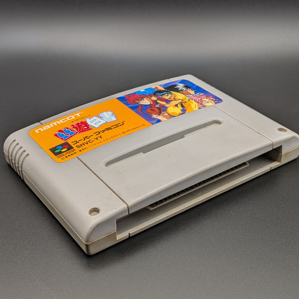 Yu Yu Hakusho video game cartridge for Nintendo's Super Famicom (SFC) Entertainment System, shown laying on its back with the label facing upwards. Showing the left hand side and bottom slot. It is displayed on a dark grey background.