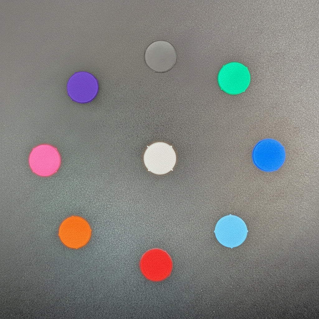 Nine circular buttons of different colors, including pink, orange, purple, green, blue, and silver, arranged in a circle on a textured gray background.